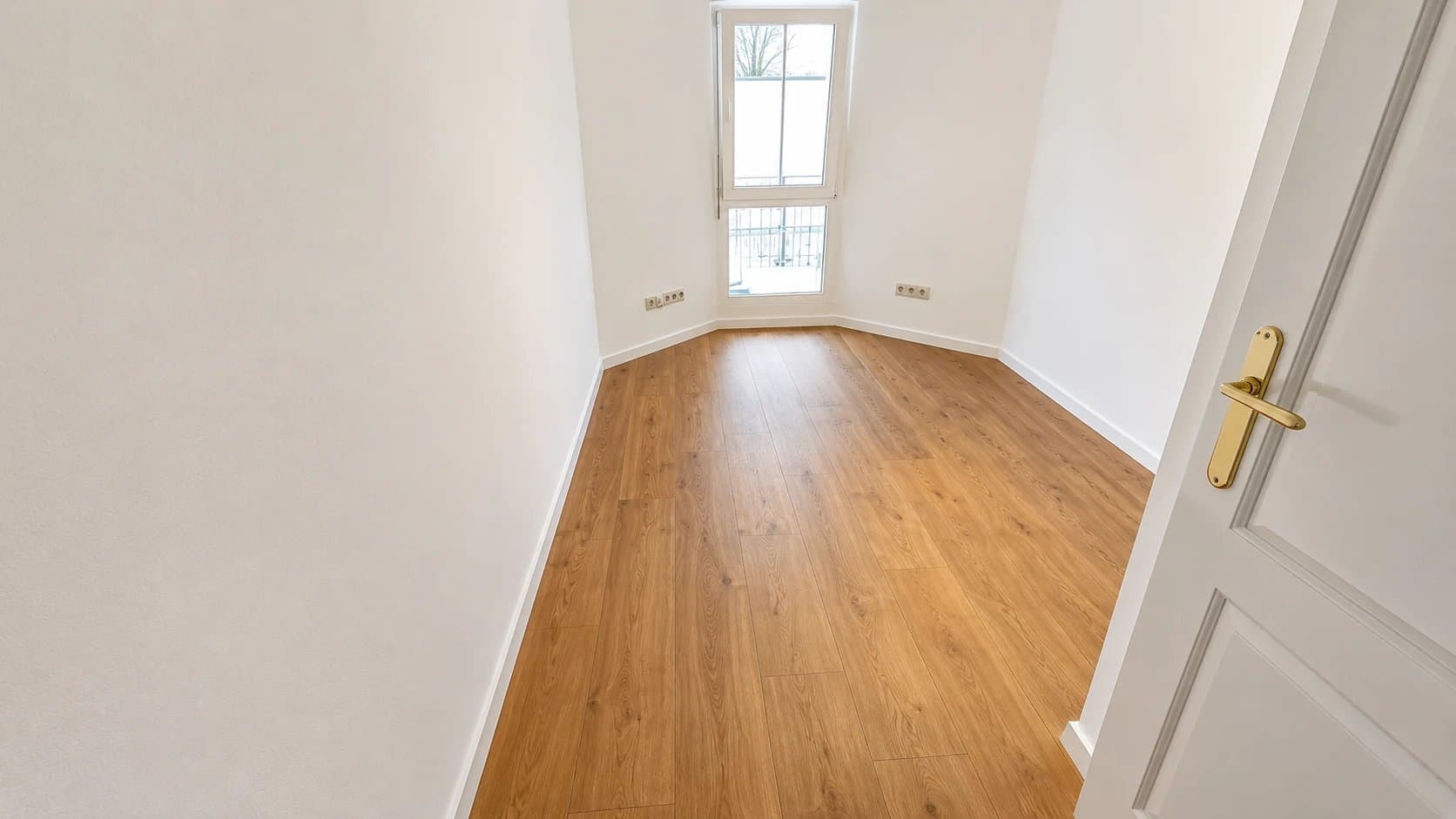 Heller Wohnraum mit neu verlegtem Laminat und frisch gestrichenen Wänden